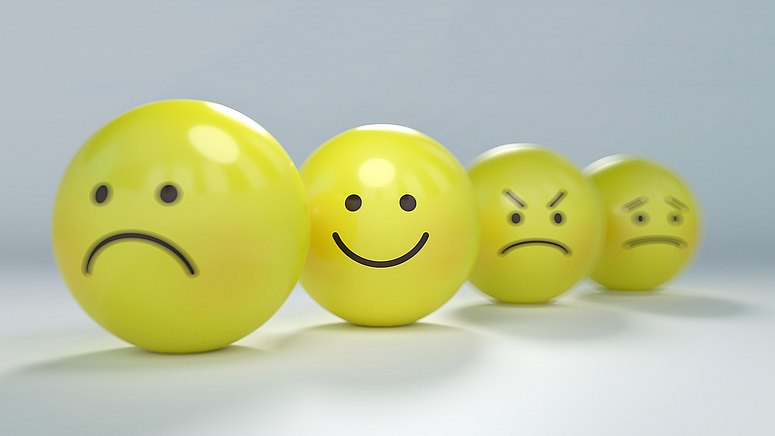 Lachende und traurige Smileys – Stimmungsschwankungen